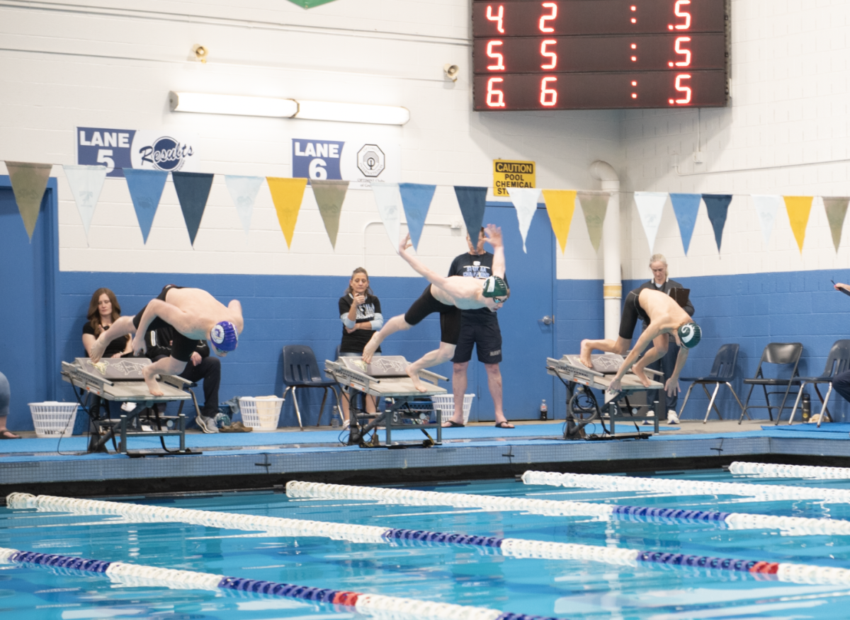 2.14.26 
(Left to Right) Freshman Isaac Jakub and Senior Maclayn Clark jump off of the blocks to start the Boys 500 Freestyle Finals. 