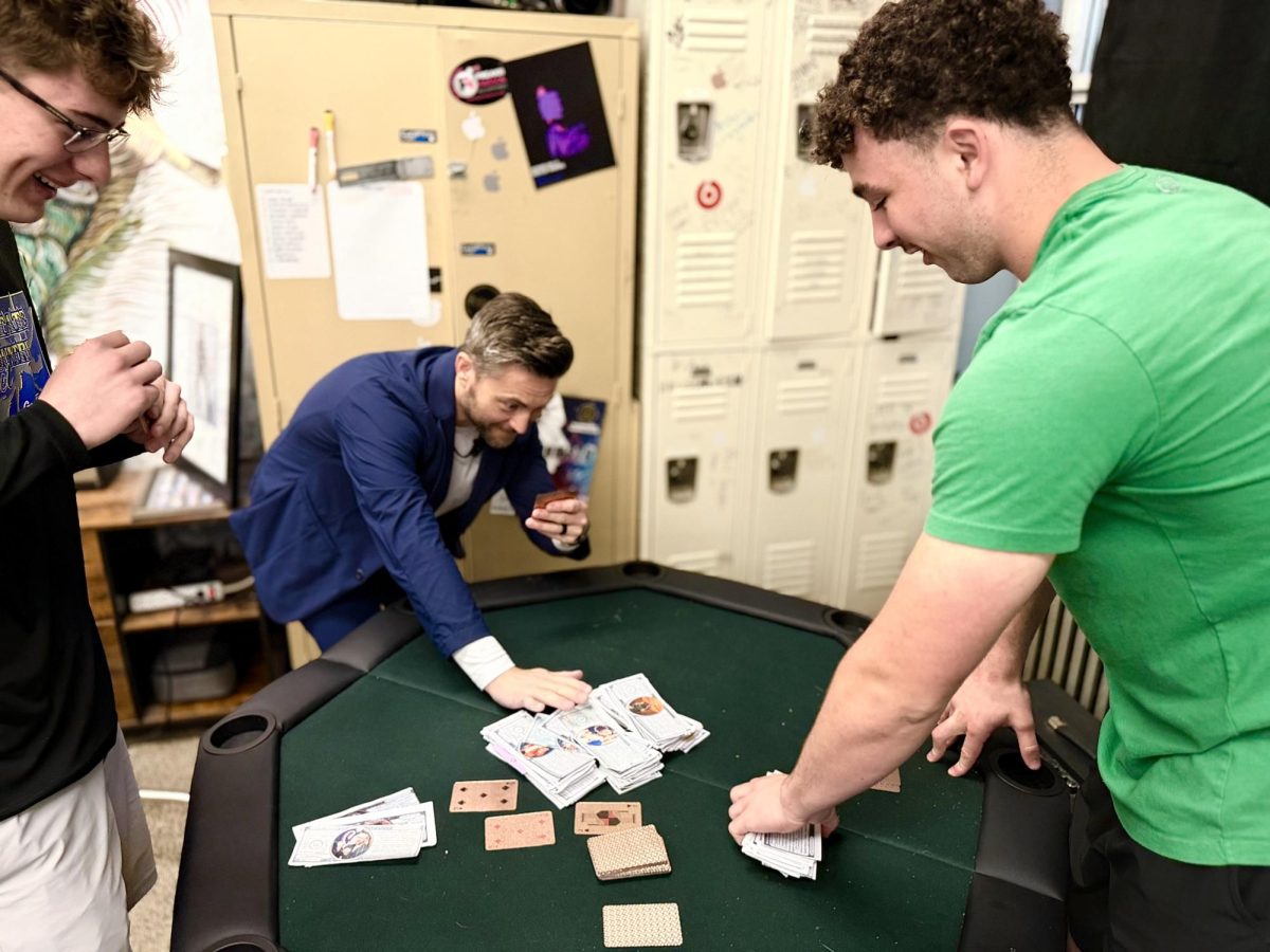 3.26.26
(Middle) History teacher Mr. Shane Fairbanks goes all in on a hand of poker against (from L to R) junior Caleb Kay and Junior Paxton Prill. 