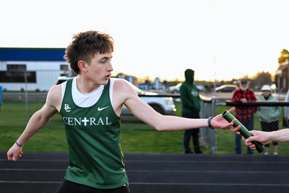 4.14.26 Freshman Callem Weisen recieving the baton to sprint off for his section of the 4x4 Relay.