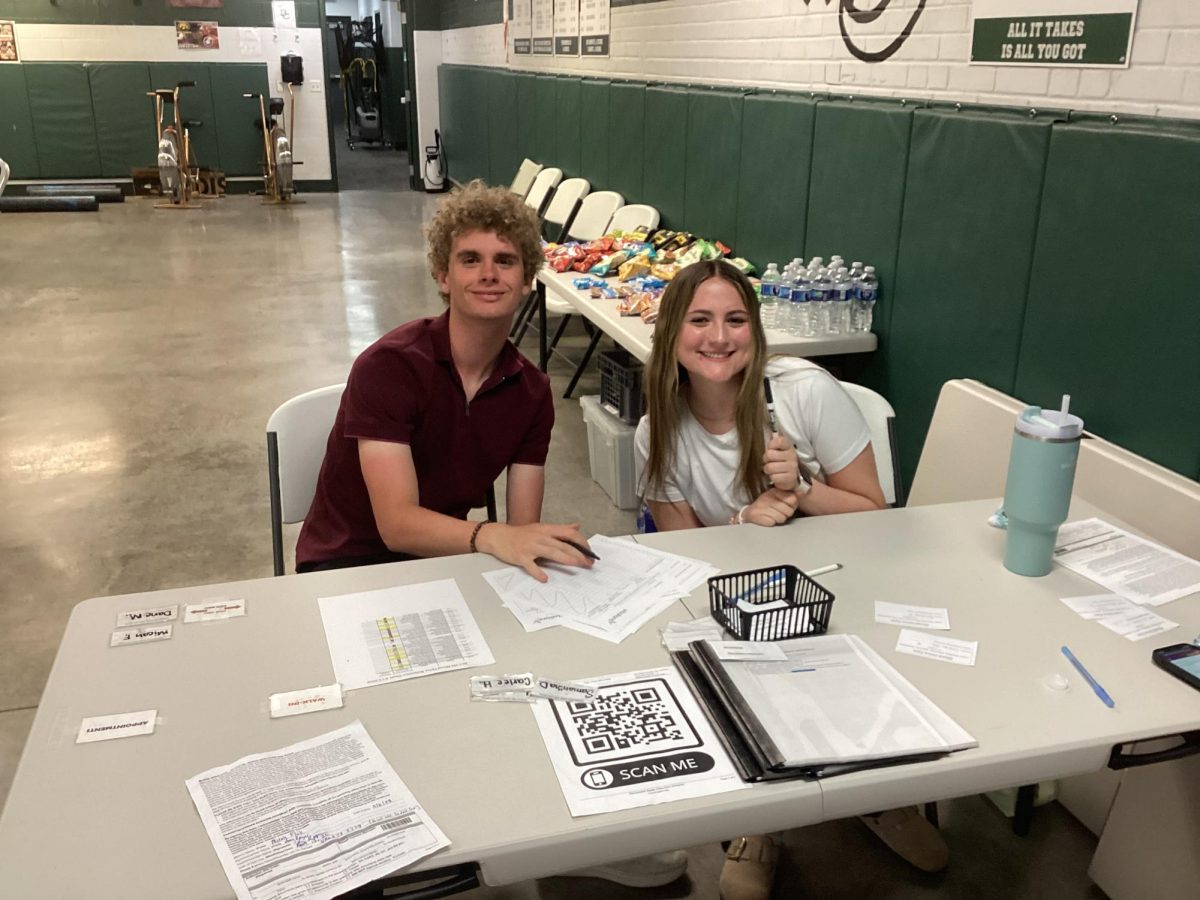 4.13.26 
(From L to R) 
Seniors, Alex Johnson and Ella Fairbanks, President and Secretary of National Honors Society volunteering by signing blood donors in. 