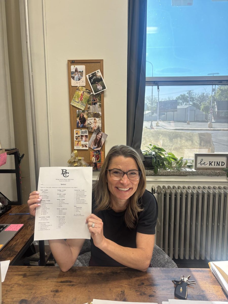 5.14.26
Counselor Angela Hirt, holding a sheet that contains New Course Offerings for next year's seniors